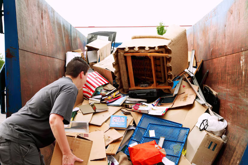 woman-with-cardboard-garbage-heap-truck_1048944-28732601
